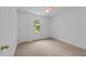 Bright bedroom featuring a ceiling fan, neutral carpet and a window overlooking the yard at 5401 Lower Creek Ct, Apex, NC 27539