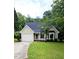 Charming single-story home featuring a one-car garage, lush lawn, and mature trees at 5401 Lower Creek Ct, Apex, NC 27539