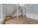 Spacious foyer showcasing updated flooring, stairway and white painted columns and wainscoting at 5401 Lower Creek Ct, Apex, NC 27539