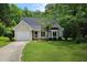 Charming single-Gathering home featuring a well-manicured front yard and attached one-car garage at 5401 Lower Creek Ct, Apex, NC 27539
