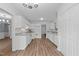 Bright kitchen features white cabinetry, granite countertops, and wood-look flooring at 5401 Lower Creek Ct, Apex, NC 27539