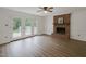 Bright living room featuring hardwood floors, a brick fireplace, and French doors to the deck at 5401 Lower Creek Ct, Apex, NC 27539