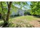 Spacious backyard featuring a lush lawn, mature trees, and a charming patio area, perfect for outdoor entertaining at 5404 Onyx Mill Ct, Raleigh, NC 27616
