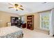 This bedroom features a ceiling fan, neutral colors, a built-in desk and bookcase, and great natural light at 5404 Onyx Mill Ct, Raleigh, NC 27616