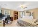 Bedroom featuring a ceiling fan, natural light and built in storage, a desk and bookcase with neutral paint at 5404 Onyx Mill Ct, Raleigh, NC 27616