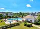 Aerial view of community pool and clubhouse surrounded by lush greenery, creating a perfect place for leisure and recreation at 5404 Onyx Mill Ct, Raleigh, NC 27616