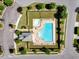 Aerial view of the community pool with lounge chairs, a clubhouse, and parking, creating a perfect social space at 5404 Onyx Mill Ct, Raleigh, NC 27616