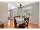 Dining room featuring wood floors, a chandelier, and a view to the entryway at 5404 Onyx Mill Ct, Raleigh, NC 27616