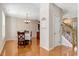 Bright dining room showcasing hardwood floors, traditional furnishings, and staircase at 5404 Onyx Mill Ct, Raleigh, NC 27616