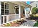 Inviting front porch featuring stone accents, decorative wreath, and manicured landscaping at 5404 Onyx Mill Ct, Raleigh, NC 27616