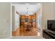 Open kitchen with wooden cabinetry, dining table and chairs, and hardwood floors at 5404 Onyx Mill Ct, Raleigh, NC 27616