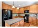 Functional kitchen featuring wood cabinetry, a central island, and modern appliances at 5404 Onyx Mill Ct, Raleigh, NC 27616
