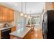 Well-lit kitchen with wood cabinets, stainless steel appliances, and an attached dining area at 5404 Onyx Mill Ct, Raleigh, NC 27616