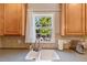 Kitchen sink with wood cabinets, providing a view of the outdoors at 5404 Onyx Mill Ct, Raleigh, NC 27616