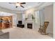 Open-concept living room with fireplace, lots of natural light, and view to kitchen at 5404 Onyx Mill Ct, Raleigh, NC 27616
