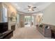 Spacious living room featuring a cozy fireplace, lots of natural light, and neutral carpet at 5404 Onyx Mill Ct, Raleigh, NC 27616