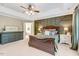 Spacious main bedroom features tray ceilings, decorative wood paneling, neutral colors, and lots of natural light at 5404 Onyx Mill Ct, Raleigh, NC 27616
