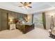 Spacious main bedroom features tray ceilings, decorative wood paneling, neutral colors, and lots of natural light at 5404 Onyx Mill Ct, Raleigh, NC 27616