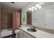 Bathroom featuring a tub-shower combo with tiled walls and a dark vessel sink at 5604 Hideaway Dr, Chapel Hill, NC 27516