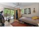 Cozy bedroom with hardwood floors, bed, ceiling fan, access to deck, and a unique wooden sauna at 5604 Hideaway Dr, Chapel Hill, NC 27516