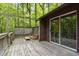 Wooden deck with outdoor seating and a sliding glass door leading to the interior at 5604 Hideaway Dr, Chapel Hill, NC 27516