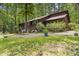 Spacious home exterior with expansive yard, patio, and lush surrounding greenery at 5604 Hideaway Dr, Chapel Hill, NC 27516