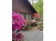 Charming home exterior with colorful azalea bushes and a gravel pathway, adding to its curb appeal at 5604 Hideaway Dr, Chapel Hill, NC 27516