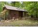 Rustic home exterior with charming star detail and neatly stacked firewood at 5604 Hideaway Dr, Chapel Hill, NC 27516