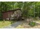 Cabin with a wooden ramp surrounded by trees and beautiful bushes at 5604 Hideaway Dr, Chapel Hill, NC 27516