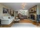 Open-concept living room with stone fireplace and access to kitchen area at 5604 Hideaway Dr, Chapel Hill, NC 27516