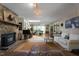 Spacious living room with stone fireplace, hardwood floors, and skylight feature at 5604 Hideaway Dr, Chapel Hill, NC 27516