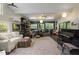 Spacious living room with large windows and a variety of musical instruments displayed throughout the space at 5604 Hideaway Dr, Chapel Hill, NC 27516
