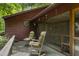 Cozy screened-in porch with comfortable seating and rustic charm at 5604 Hideaway Dr, Chapel Hill, NC 27516
