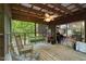 Inviting screened porch with swing and rocking chair, perfect for relaxation and enjoying the outdoors at 5604 Hideaway Dr, Chapel Hill, NC 27516