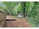Landscaped backyard with a wooden shed, trees, and chainlink fence at 5804 Heatherbrook Cir, Raleigh, NC 27612