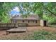 Back exterior view of home with yard, deck, and storage building at 5804 Heatherbrook Cir, Raleigh, NC 27612