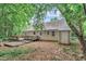 Back exterior view of home with yard, deck, and storage building at 5804 Heatherbrook Cir, Raleigh, NC 27612