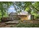 A backyard featuring a weathered deck, shed, and a canopy of trees overhead at 5804 Heatherbrook Cir, Raleigh, NC 27612
