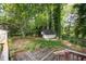 A large wooded backyard featuring mature trees and a storage shed offers privacy and space at 5804 Heatherbrook Cir, Raleigh, NC 27612