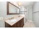 Updated bathroom with double sinks, granite countertop, and a tiled walk-in shower at 5804 Heatherbrook Cir, Raleigh, NC 27612