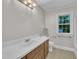 Bathroom featuring a vanity with a white countertop, with a window and neutral tones at 5804 Heatherbrook Cir, Raleigh, NC 27612