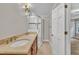Bathroom featuring double vanity with framed mirror and tiled walk-in shower at 5804 Heatherbrook Cir, Raleigh, NC 27612