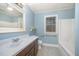 Well-lit bathroom with large vanity, mirror, and tub/shower combination at 5804 Heatherbrook Cir, Raleigh, NC 27612