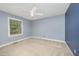A light blue bedroom with a window, ceiling fan, and carpeted floor offers a serene space at 5804 Heatherbrook Cir, Raleigh, NC 27612