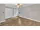 Bright bedroom with wood-look floors, neutral walls, two closets, and a ceiling fan at 5804 Heatherbrook Cir, Raleigh, NC 27612