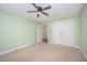 Bedroom with neutral carpet, a ceiling fan, and a closet for storage at 5804 Heatherbrook Cir, Raleigh, NC 27612