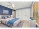 Comfortable bedroom with blue accent wall, ceiling fan, and natural light from large window at 5804 Heatherbrook Cir, Raleigh, NC 27612