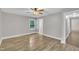 Bedroom with new wood floors and large windows bringing in natural light at 5804 Heatherbrook Cir, Raleigh, NC 27612