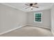 Neutral bedroom with carpet, ceiling fan, and window bringing in natural light at 5804 Heatherbrook Cir, Raleigh, NC 27612