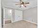 Bedroom with carpet, ceiling fan, and white closet door with entry way at 5804 Heatherbrook Cir, Raleigh, NC 27612